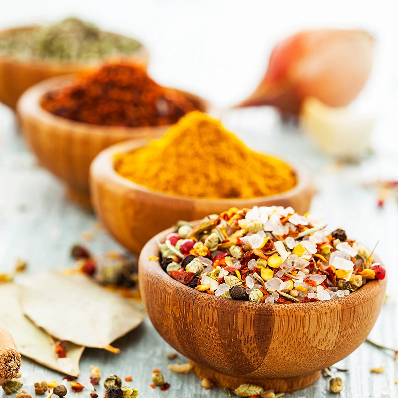 Wooden bowls filled with spices on the table