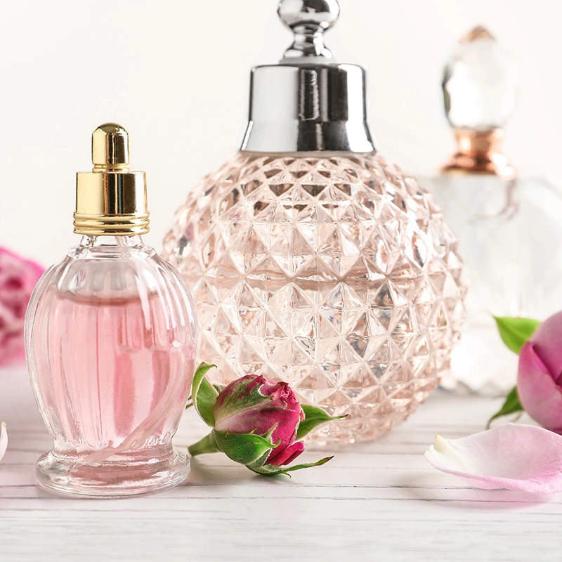 Perfumes on the table surrounded with flowers